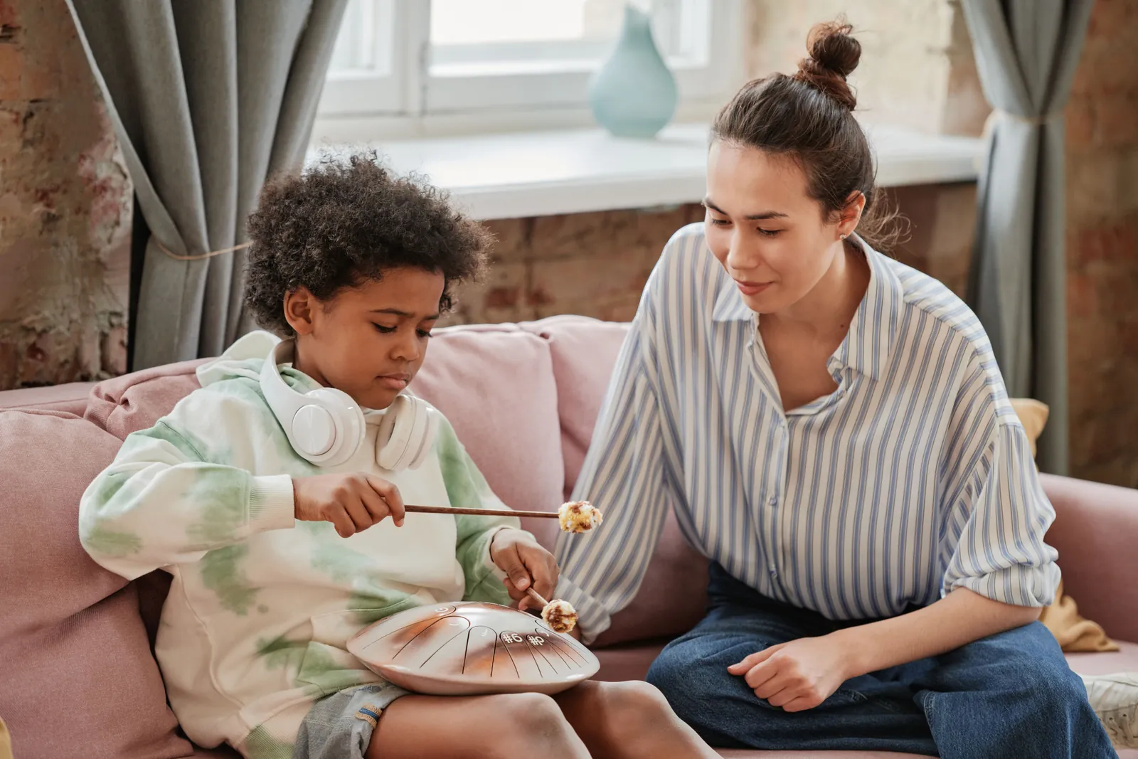 Adult and child using a musical instrument during an interaction activity