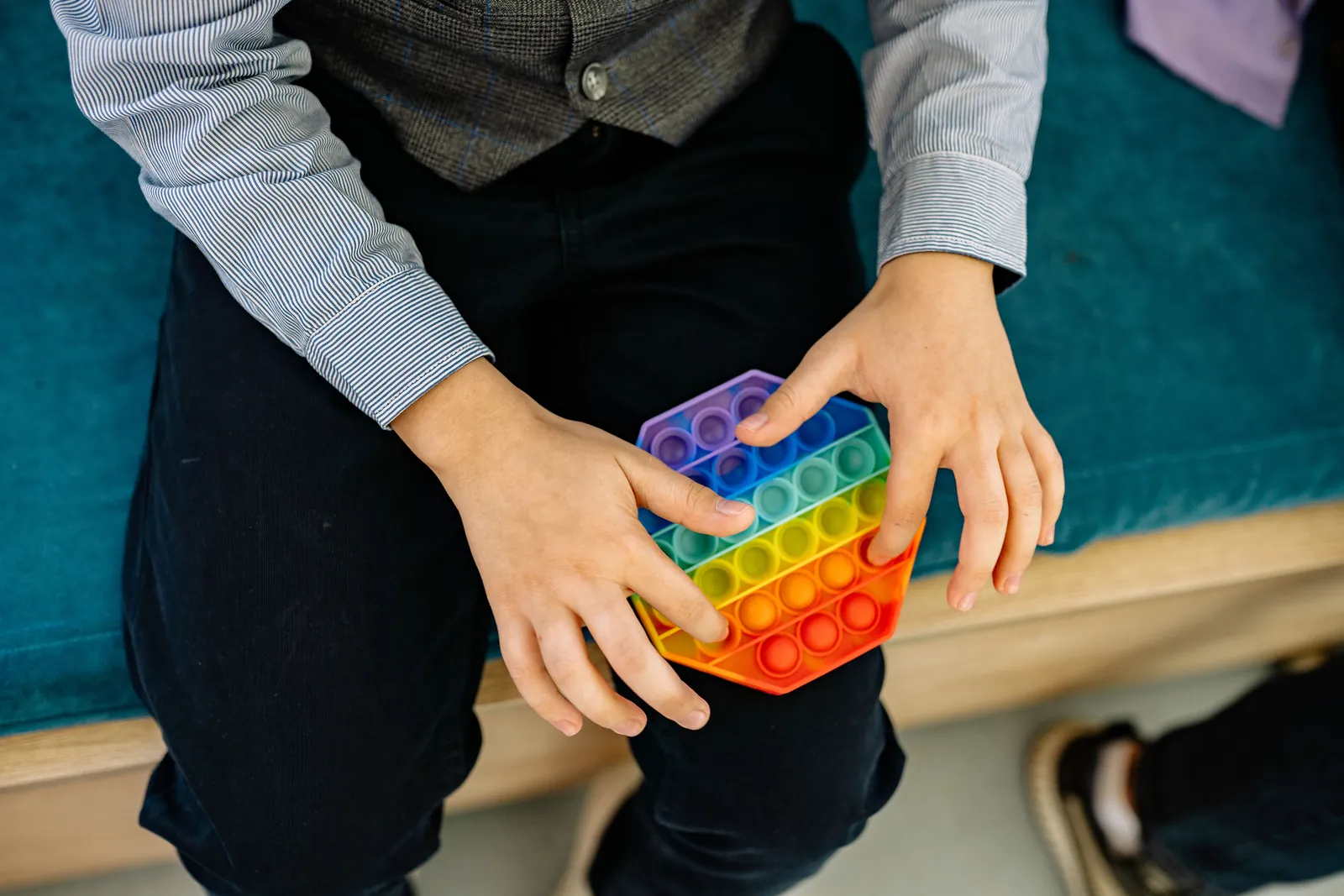 Child using a colourful sensory fidget toy
